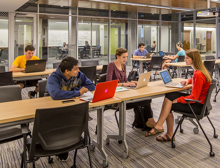 students gathered at a table in the library