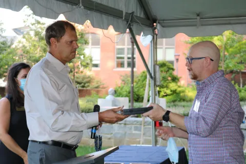 School of Biological Sciences professor Joel Kostka presents Steve Diggle (right) with his Cullen-Peck Faculty Fellowship Award (Photo Renay San Miguel)