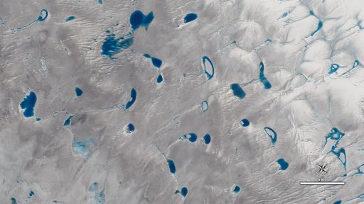 A view of Greenland's ice sheet from the NASA/USGS Landsat 8 satellite showing meltwater lakes on a glacier. (Credit: NASA)